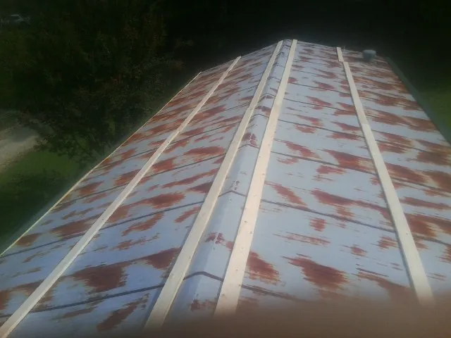Rusted metal roof panels with new wood purlins before replacement — Storm Damage Roof Repair in Battle Ground by Roofing Brothers